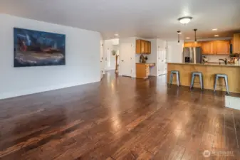 Back inside you will find the open layout flows into the kitchen area and includes bar style seating at the kitchen island.