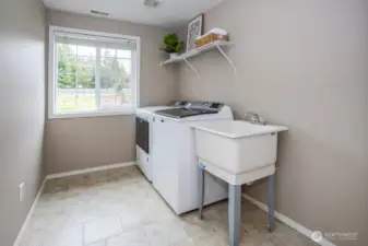 Massive utility room with convenient utility sink and room for more laundry tools!
