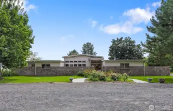 Front entrance with circular driveway for ease with horse trailers and large vehicles. Enjoy the beautiful landscaping. There is an RV dump off by the septic tank.