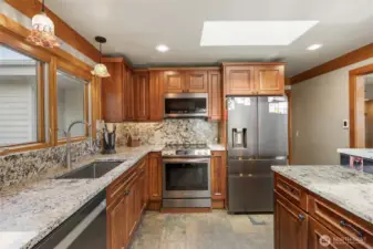 Lots of recessed lighting above and below the custom cabinets. Pull out garbage bin for easy clean up.