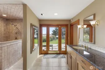 Luxury primary bathroom with heated travertine flooring.