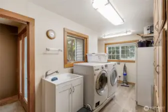 Spacious laundry room with wall to wall built in storage. Washer and dryer are included.
