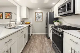 The kitchen features a new gas range and all newer appliances.