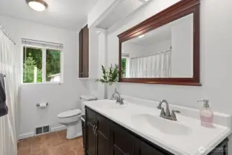 The bathroom is spacious with double vanity sinks.