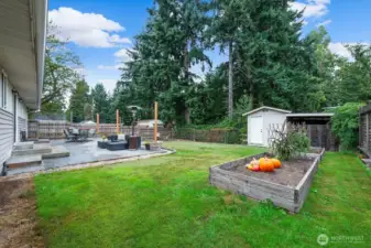 The rear yard has so much room to play, garden, and entertain.