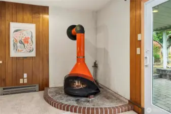Bring warmth and a splash of fun with this vibrant orange wood-burning fireplace