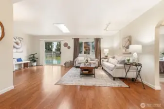 This bright, open living space offers a comfortable and inviting atmosphere. Its generous size allows for multiple seating configurations and versatile day-to-day living.