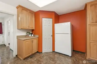 From the spacious kitchen, the convenient walk-through to the utility room (to the left) connects the back entry to the kitchen—perfect for easy grocery drop-off and storage.