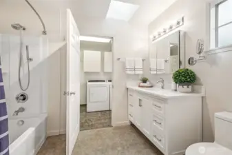 Remodeled primary bath with skylight and direct access to laundry and side entry—convenience and style meet function!