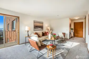 Spacious living room with big windows, lots of natural light & balcony with a view of the Olympic Mtns, Puget Sound & gorgeous sunsets. Freshly painted & new carpet throughout.