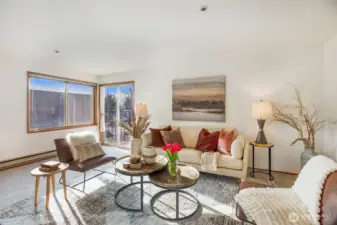 Spacious living room with big windows, lots of natural light & balcony with a view of the Olympic Mtns, Puget Sound & gorgeous sunsets. Freshly painted & new carpet throughout.