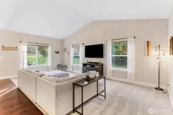 Main living space with vaulted ceilings and abundant lighting