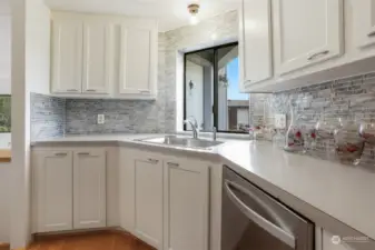 Updated kitchen with laminate flooring, refaced cabinets, stainless appliances and an eating bar.