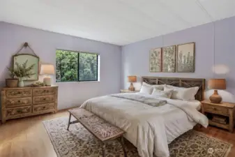 Master bedroom suite features laminate flooring, walk in closet and a 4 piece remodeled bathroom.   Virtually staged photo