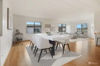 Formal dining room with laminate flooring and a built in hutch,  opens to the kitchen eating bar and living room.  Virtually staged photo