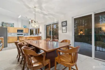 Dining area of great room w/large slider to large deck.  Bright kitchen beyond.