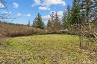 HUGE area, perfect for future shop/garage w/possible MIL/ADU.  Stakes are just to give you a visual of what 24x22 looks like.  Plenty of room to build bigger than that.  Buyer to verify. Seller paid to have septic design revised & reserve moved so this back portion of property could be used.