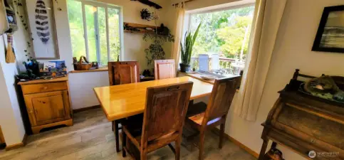 Bathed in natural light and surrounded by greenery, this inviting dining nook blends rustic charm with creative flair—perfect for morning coffee, impromptu sketches, or lingering over dinner while the garden views steal the show. A soulful space where every corner tells a story.