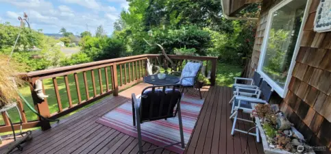 Whether you're sipping morning coffee or toasting the moonrise, this elevated deck offers a front-row seat to lush gardens, serene landscapes and Willapa Bay views - it’s a perfect spot for soaking in the coastal lifestyle.