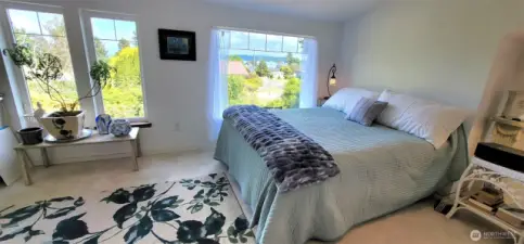 Bask in the quiet elegance of this garden-view guest room — where dappled light filters through generous windows, framing Willapa Bay views, and lush outdoor vistas.