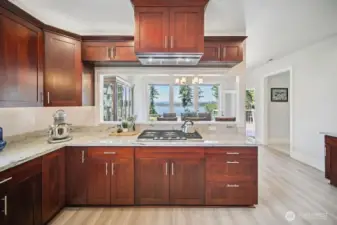 Custom cabinetry with deep drawers, soft close throughout, and SS Appliances.  Views of the Sound and open to the Great room too.