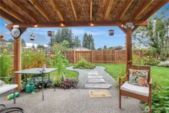 backyard covered area with firepit that was converted into a mini-Garden space.