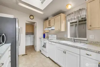 Vaulted ceilings, a big beautiful skylight, newer full-size fridge and range make cooking in this kitchen a dream!