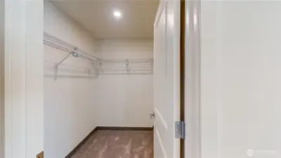 Layout of primary bedroom with ensuite to left and walk in closet