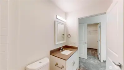 Primary bedroom ensuite looking into walk in closet