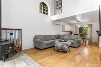 Walk into a Bright & Welcoming Living Room with vaulted ceilings & a wood stove~
