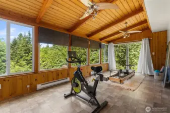 Charming sunroom featuring warm cedar ceilings and serene views of the backyard~