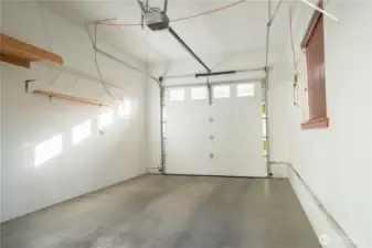 One car garage with shelving for storage.