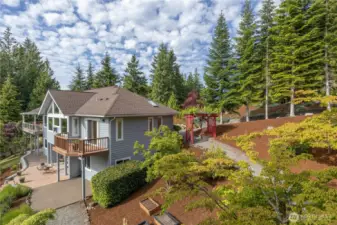 Lovely walking paths, flowering trees and shrubs, patios and an arbor with flowering vines are all part of this lovely setting and move-in-ready home.