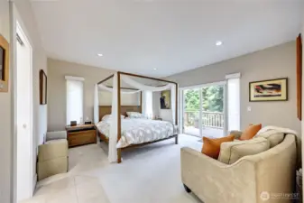 Spacious main-level primary ensuite with private deck access, walk-in closet, and a 5-piece bath.