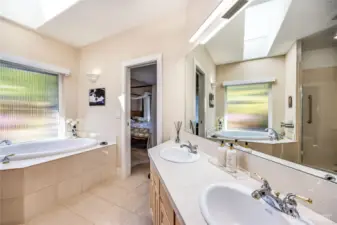 The spacious primary bath with water closet, walk-in closet and separate shower and soaking tub.