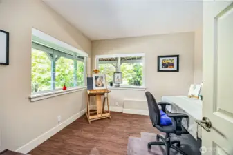 The second guest bedroom on the lower level—formerly used as an artist’s studio—features tall ceilings, abundant natural light, and a quiet corner location, making it an ideal retreat for guests or a versatile flex space.