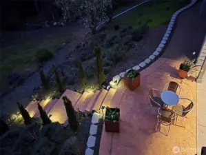 Running the full length of the house, the lower-level patio glows with ambient lighting, offering a romantic and serene atmosphere for evening relaxation.