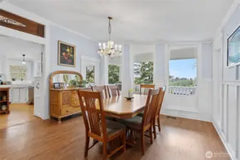 Dining room over looks the covered porch and to the eft is the kitchen with stained glass over the door way.