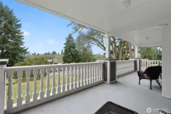 Cover porch with custom railings. This is a large space to have for entertain guests or start your morning or end your day.