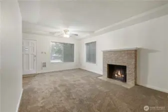 Warm and inviting Living area with beautiful brick Fire Place!