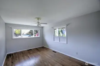 Front bedroom shows the hardwood floors lurking under carpet in other rooms