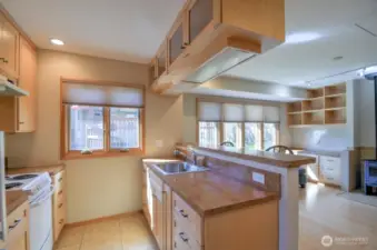 Entering ADU the galley kitchen, custom cabinetry, large eating bar, to main living area