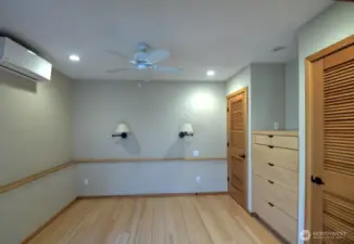 Looking into bedroom area. Notice again the great add of custom drawers between two(!) closets, and sconce lighting