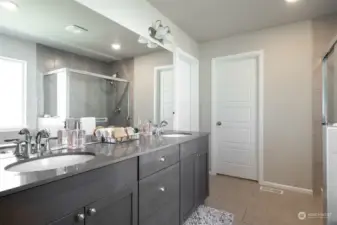 Double vanity in primary bathroom- door opens to huge walk-in closet