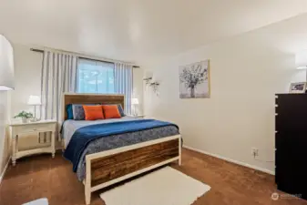 Spacious primary suite with tall ceiling and attached walk-in closet.