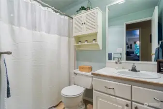 Full bath with tile flooring and countertops.