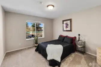 Primary bedroom is also quite large. Window looks out onto private deck.  So much light!!