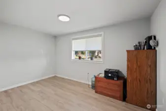 Second main floor bedroom with ensuite bath. Could be used as second primary bedroom, home office, or room rental.