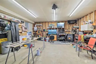 Inside of the shop/garage. Plenty of room for your tools and toys. Pellet stove will be removed. Tankless water heater.