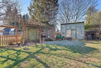 Out buildings in the corner of the yard.